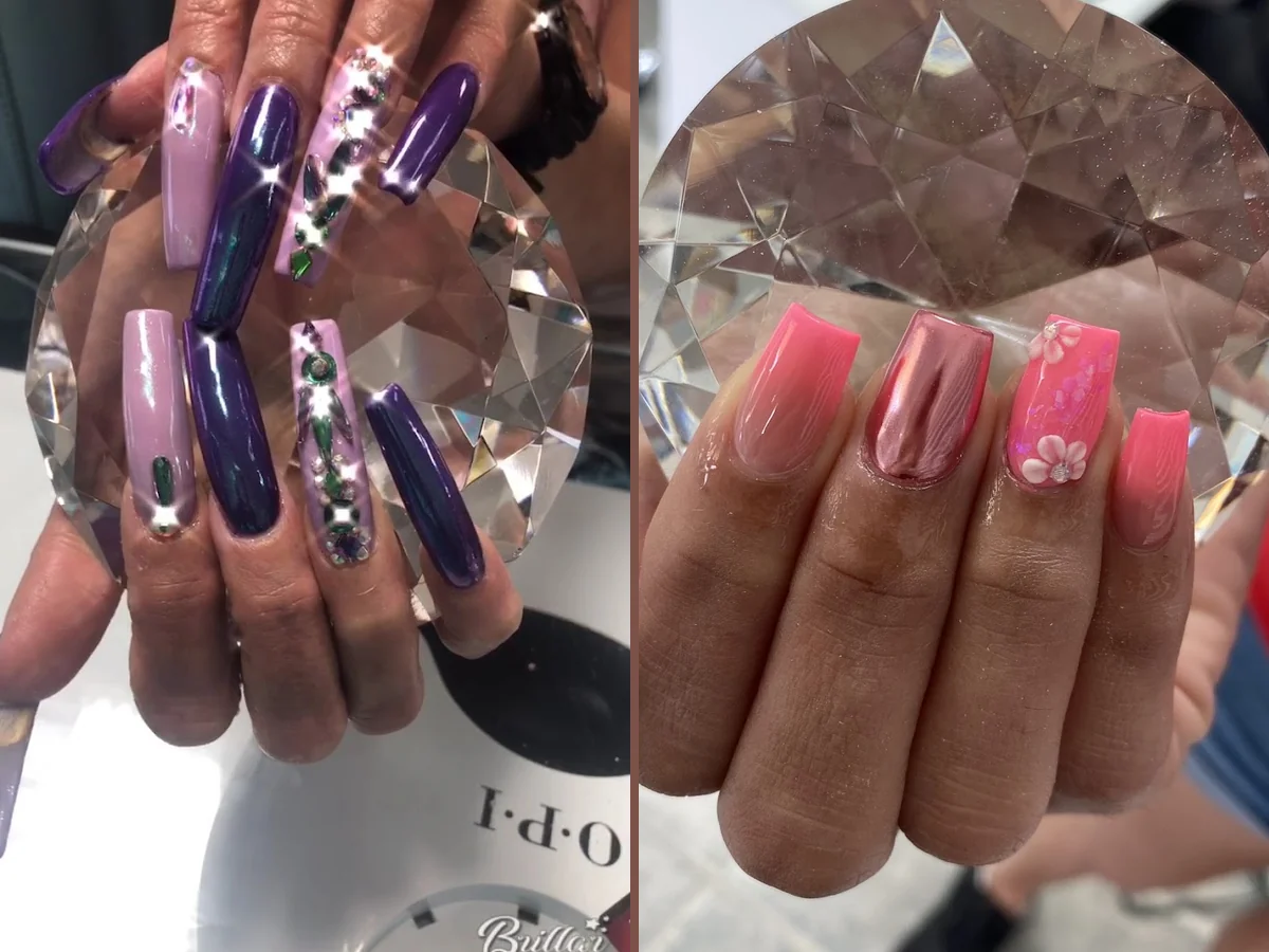 Manicured hands with glossy nails on a salon table.